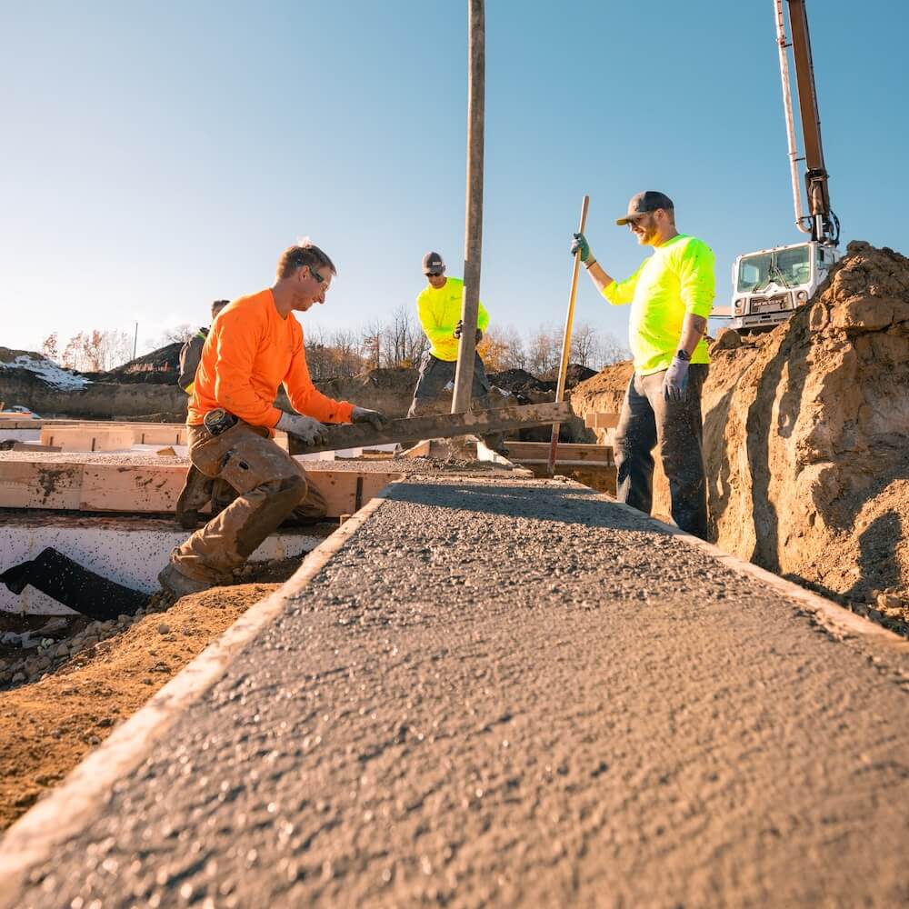 Crew preparing concrete footings for an Element ICF foundation