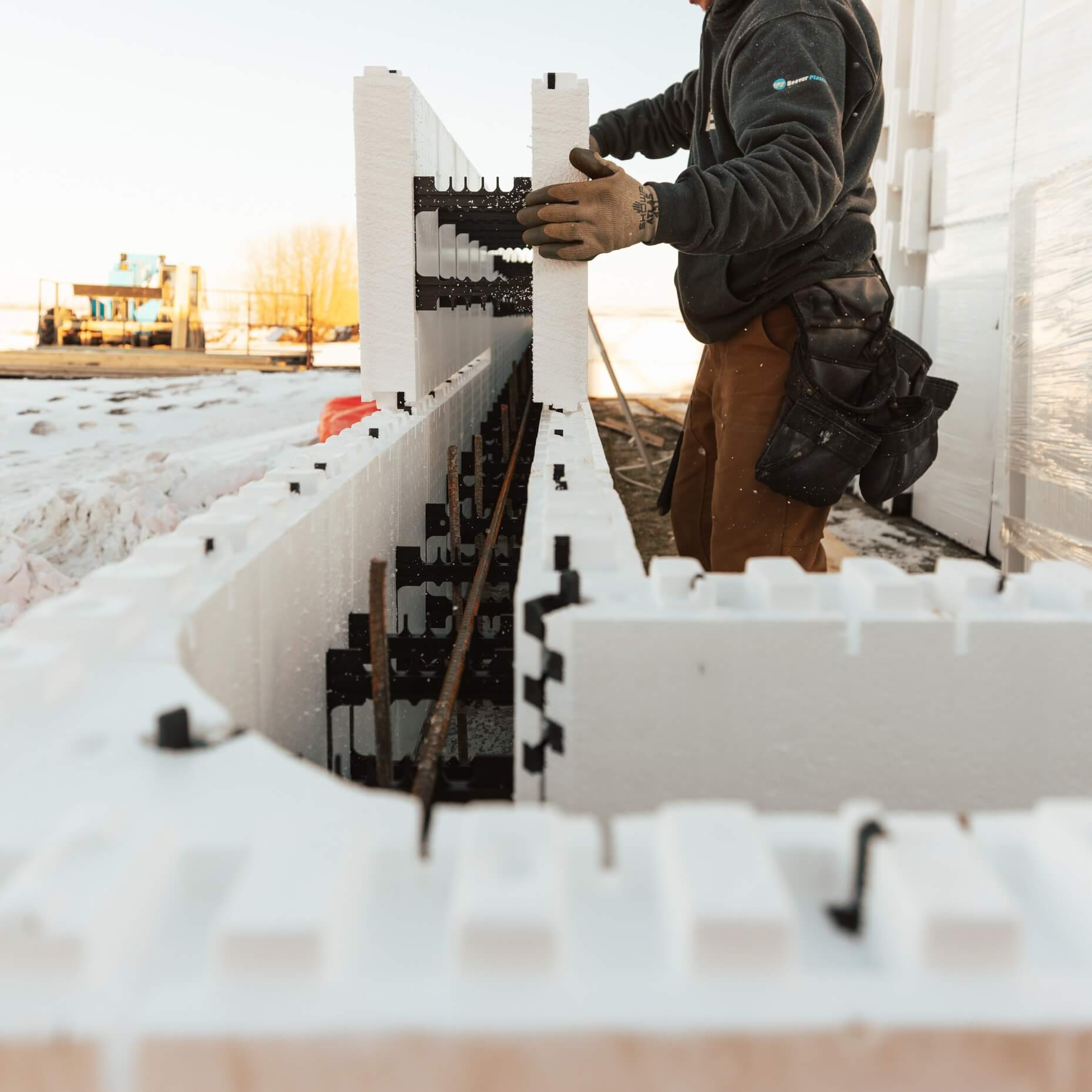 Installer stacking Element ICF forms for wall assembly
